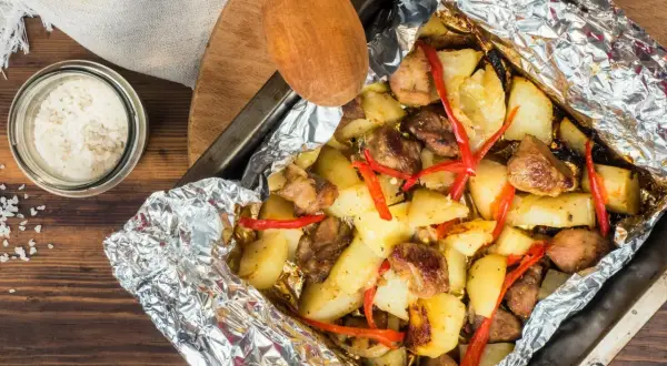 Szybki obiad z piekarnika: pieczone ziemniaki z mięsem i papryczką chili w folii aluminiowej.