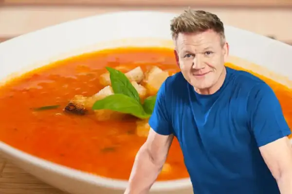 Gordon Ramsay obok miski z pomidorową zupą i grzankami.