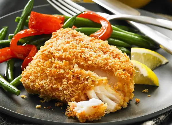 Chrupiący filet rybny w panierce panko z fasolką szparagową, papryką i cytryną.