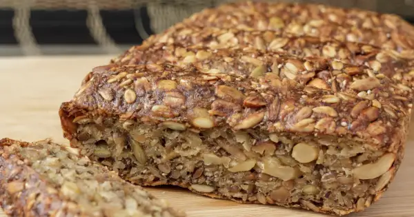 Keto chleb z ziarnami i orzechami, pokrojony na kromki.
